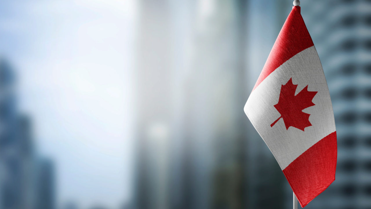 A,Small,Flag,Of,Canada,On,The,Background,Of,A