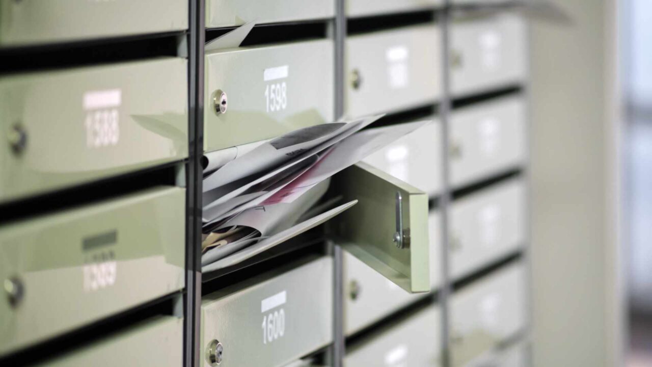 Spam is any unwanted message: Why end users should always have the final say Mailboxes in the condominium are littered with correspondence, overflowing. Paper letters lie in an open mailbox, filled with spam.