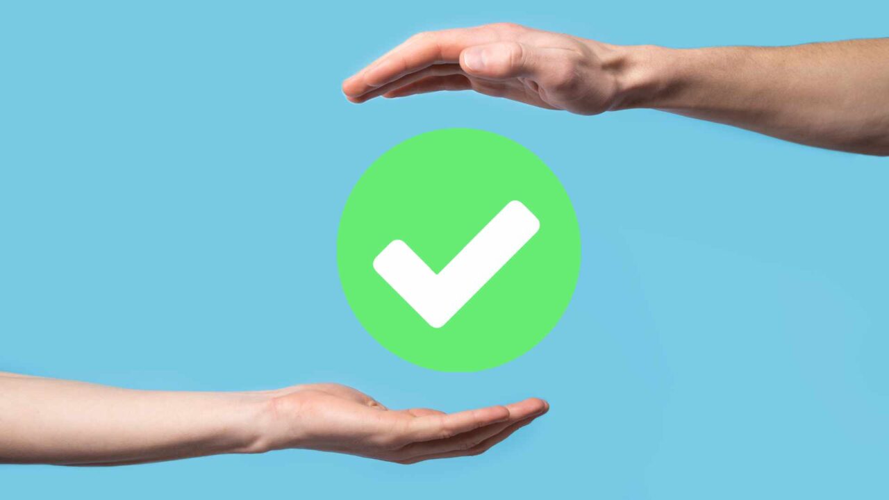 Hand holds green icon Check mark,Check Mark Sign, Tick Icon,right sign,circle green checkmark button,Done.On dark background.Banner.Copy space.Place for text.