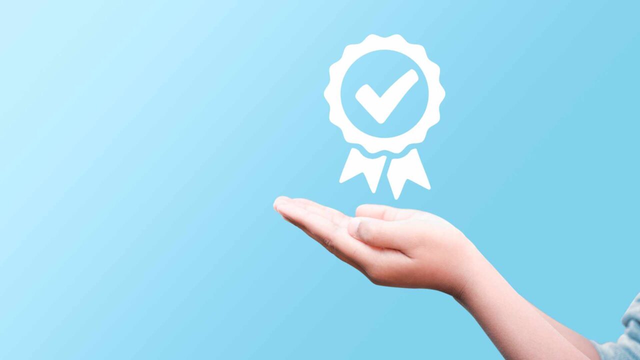 Hand shows the sign of the top service Quality, Guarantee, Stand